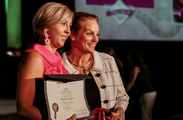 Alumnae receiving an award at convention